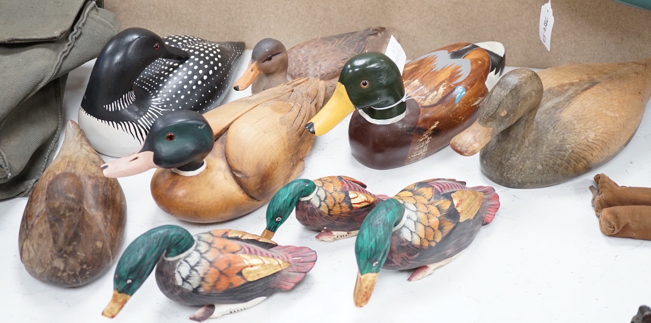 Nine carved wood decoy ducks